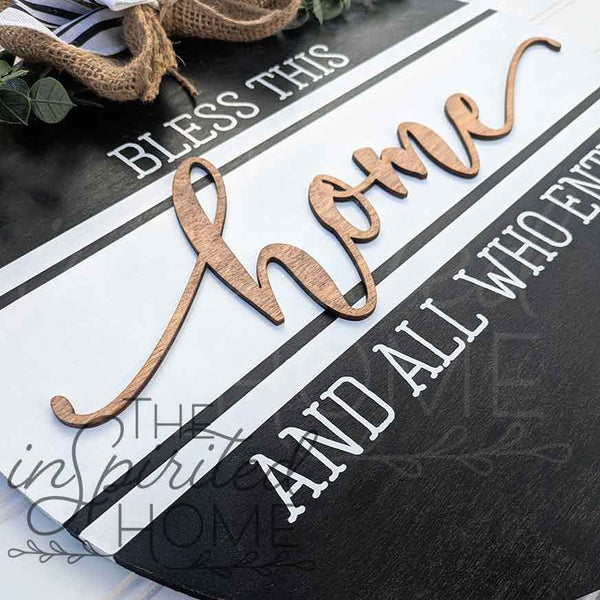 Decorative sign with wooden letters spelling 'Home' on a black and white background.